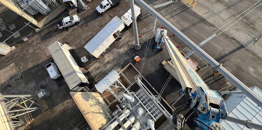 Aerial view of a large utility substation showing two distinct RMS Energy projects running concurrently, demonstrating scale and cross-collaboration.