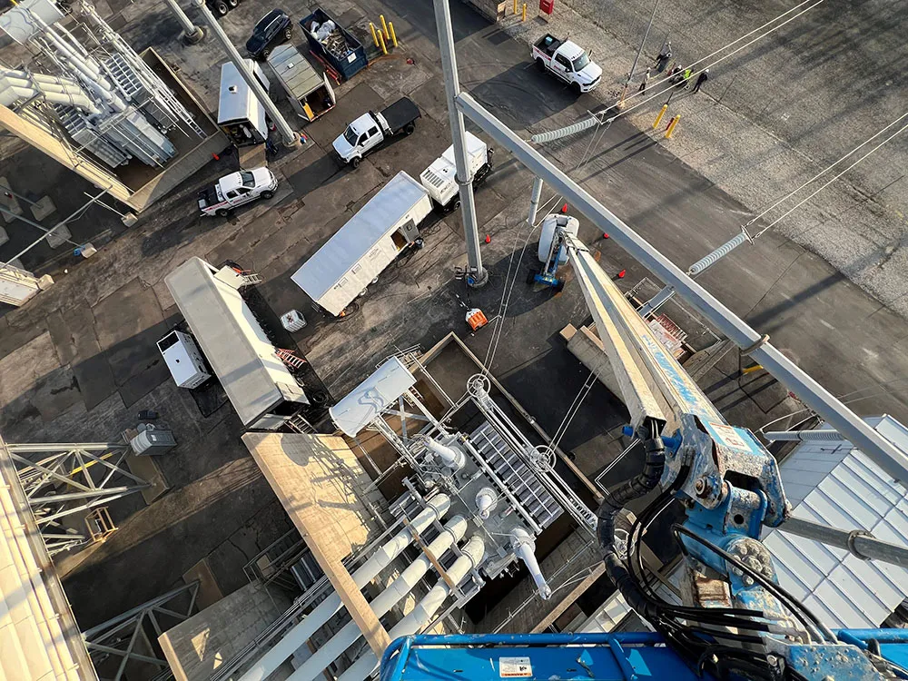 Aerial view of a large utility substation showing two distinct RMS Energy projects running concurrently, demonstrating scale and cross-collaboration.