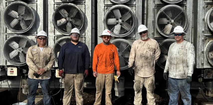 RMS Energy transformer technicians, covered in dirt and grime after successfully completing an emergency teardown and isolation of a transformer following a catastrophic failure.