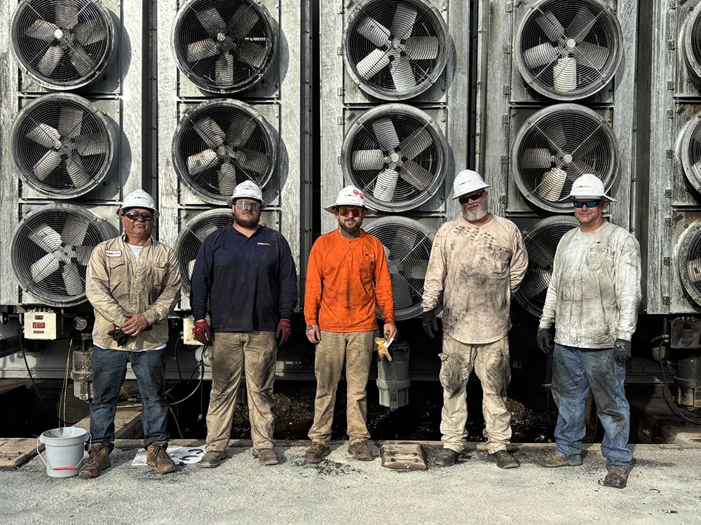 RMS Energy transformer technicians, covered in dirt and grime after successfully completing an emergency teardown and isolation of a transformer following a catastrophic failure.
